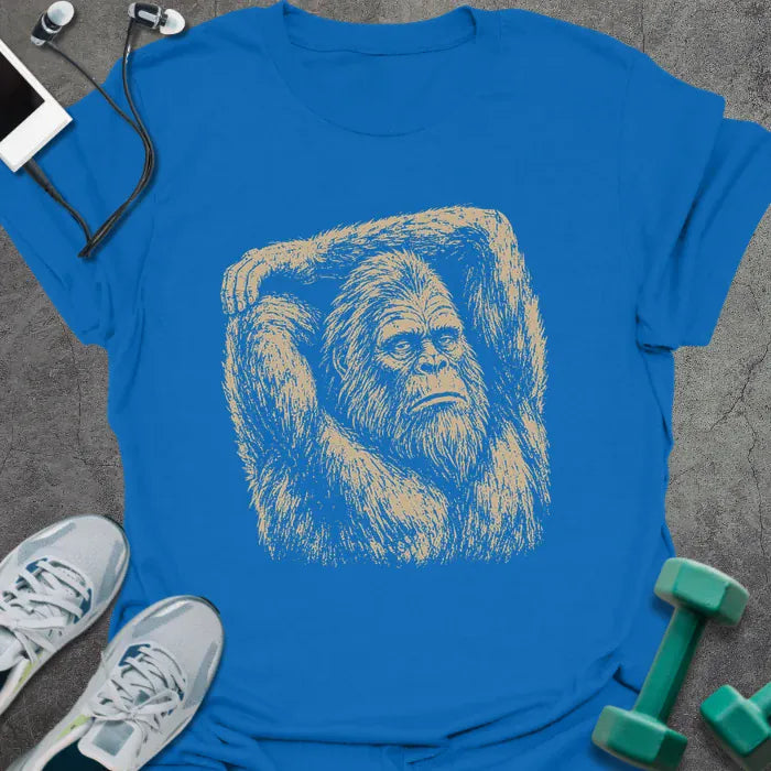 Royal blue t-shirt with an illustration of Bigfoot stretching with one arm over its head in white