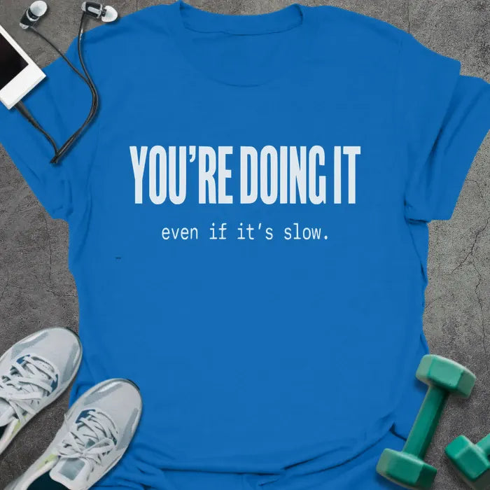 Royal blue t-shirt printed with "YOU'RE DOING IT even if it's slow." in white