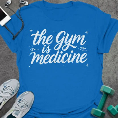 Royal blue t-shirt printed with "the gym is medicine" in white, with sparkles and decorative lines