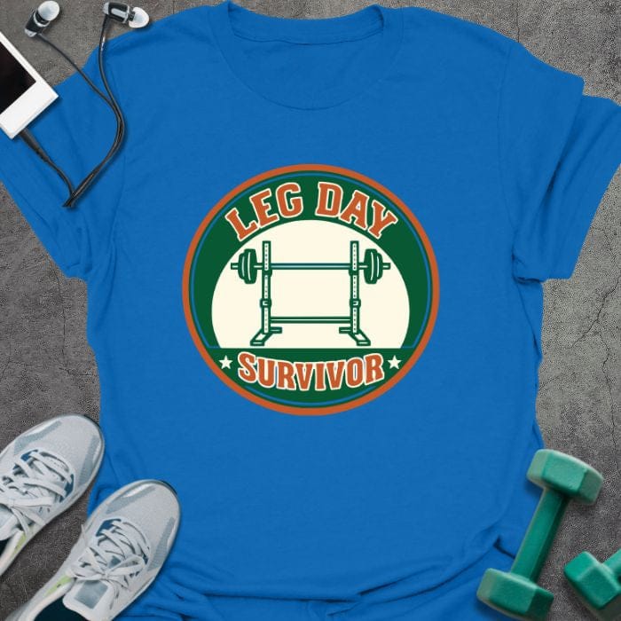 Royal blue t-shirt printed with "Leg Day Survivor" in orange and red, with barbell in circular badge