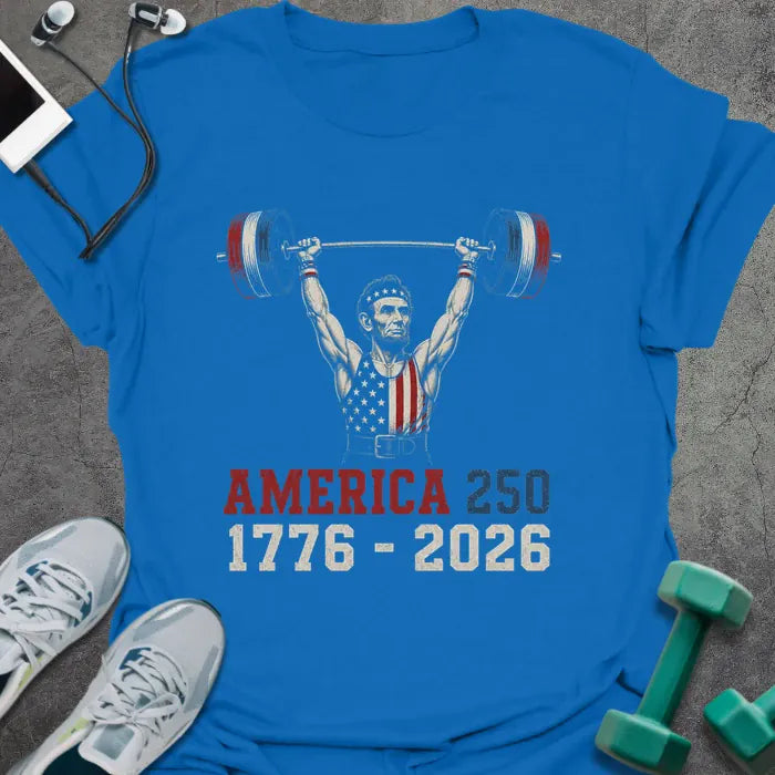 Royal blue t-shirt with Abraham Lincoln lifting dumbbells graphic in white and gold