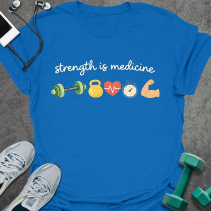 Royal blue t-shirt printed with "strength is medicine" in multicolor, with emoji icons: dumbbell, kettlebell, heart, timer, muscle