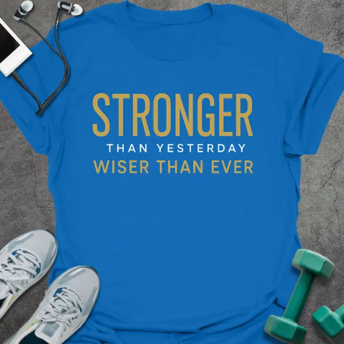 Royal blue t-shirt printed with "Stronger Than Yesterday Wiser Than Ever" in white and gold