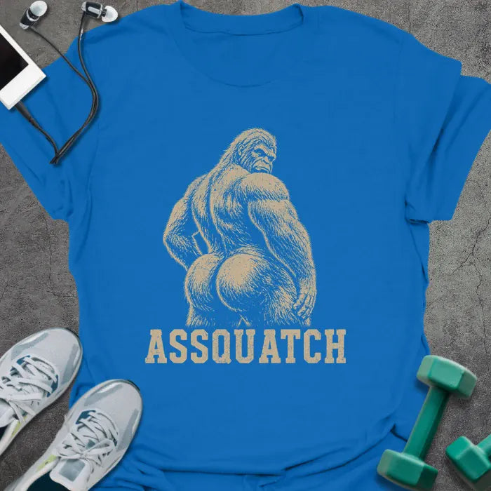 Royal blue t-shirt printed with "Assquatch" in white, with an illustration of Bigfoot from behind