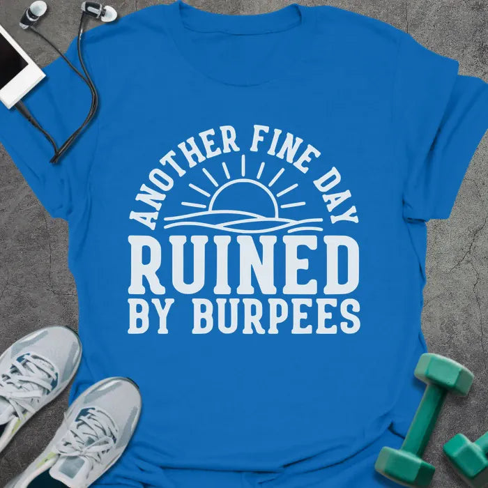Royal blue t-shirt printed with "Another Fine Day Ruined By Burpees", with an illustration of a sun