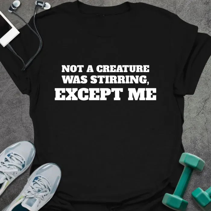 Black t-shirt printed with "NOT A CREATURE WAS STIRRING, EXCEPT ME" in white