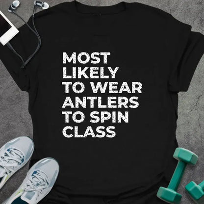 Black t-shirt printed with "MOST LIKELY TO WEAR ANTLERS TO SPIN CLASS" in white