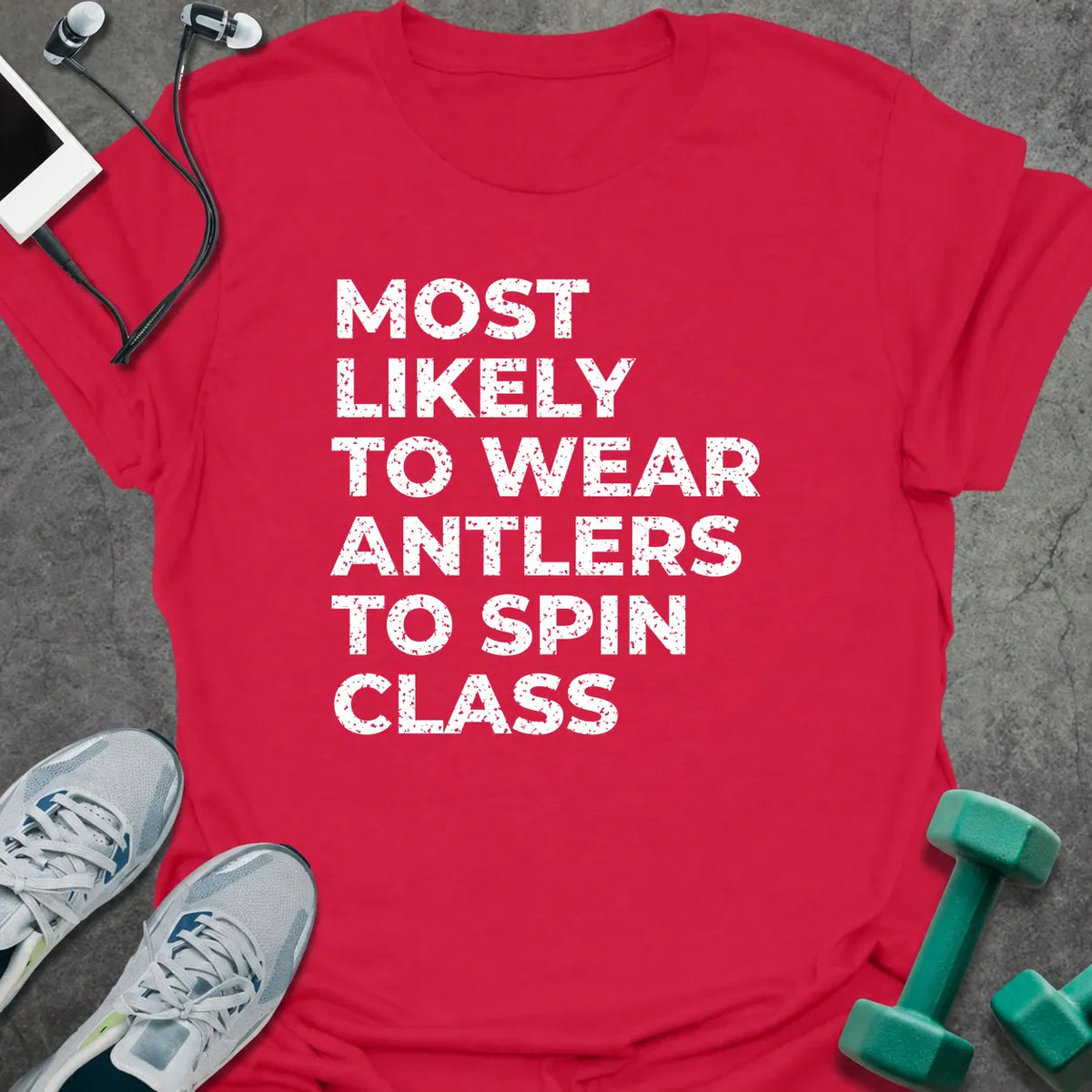 Cherry red t-shirt printed with "MOST LIKELY TO WEAR ANTLERS TO SPIN CLASS" in white