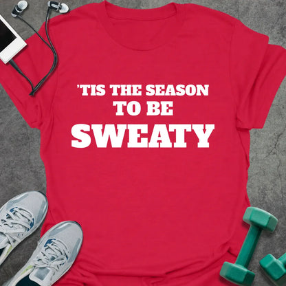 Cherry red t-shirt printed with "'TIS THE SEASON TO BE SWEATY" in white