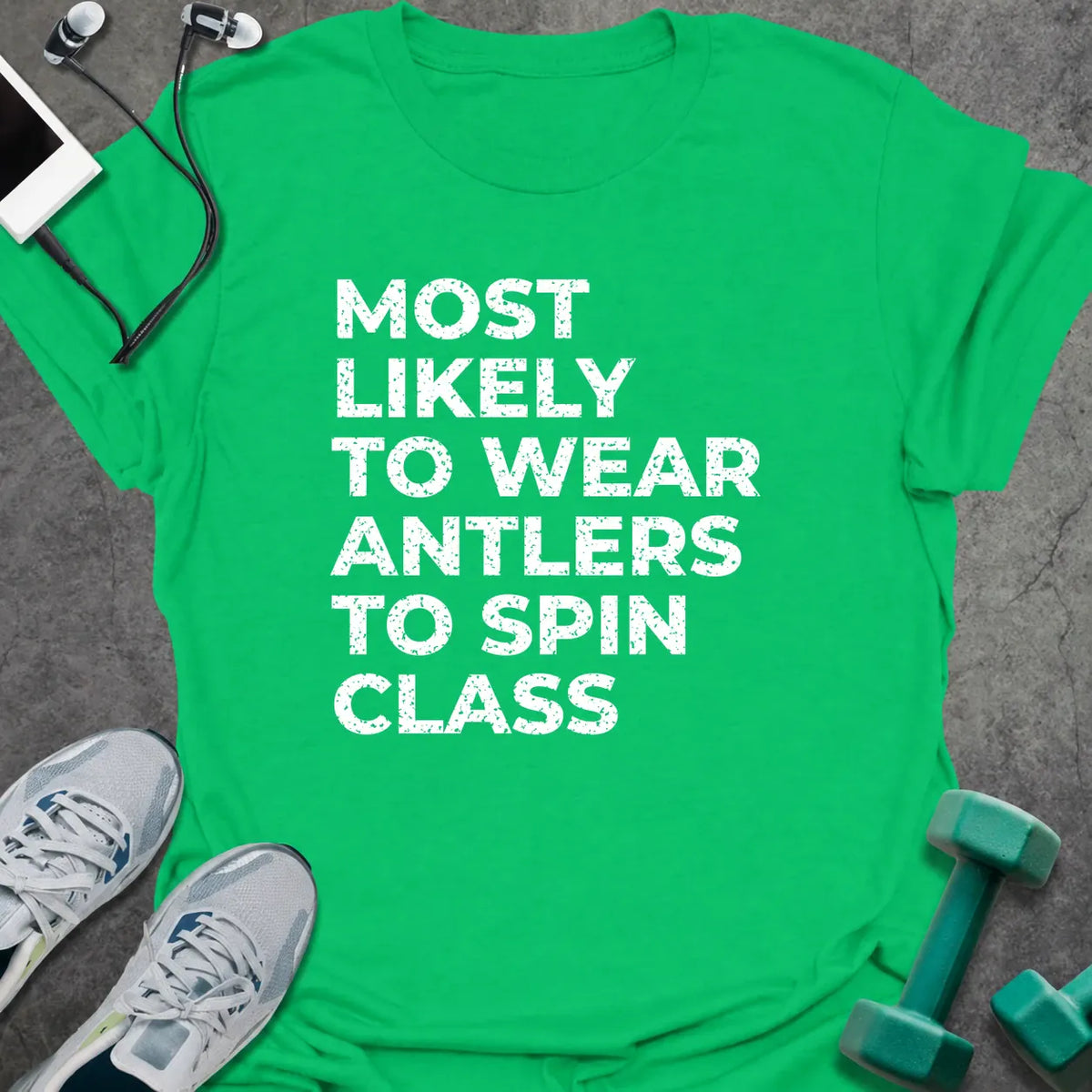 Irish green t-shirt printed with "MOST LIKELY TO WEAR ANTLERS TO SPIN CLASS" in white