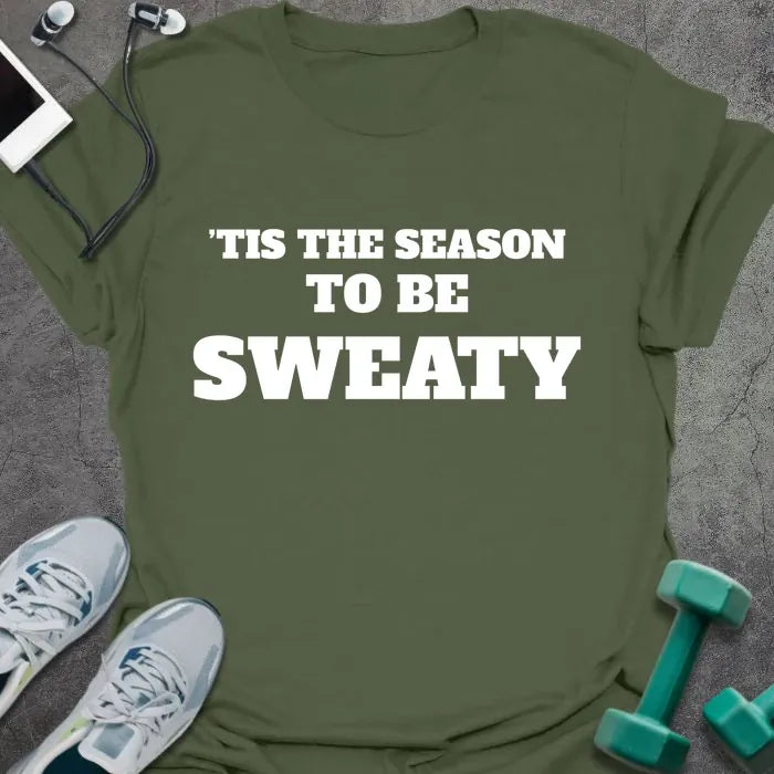 Military green t-shirt printed with "'TIS THE SEASON TO BE SWEATY" in white