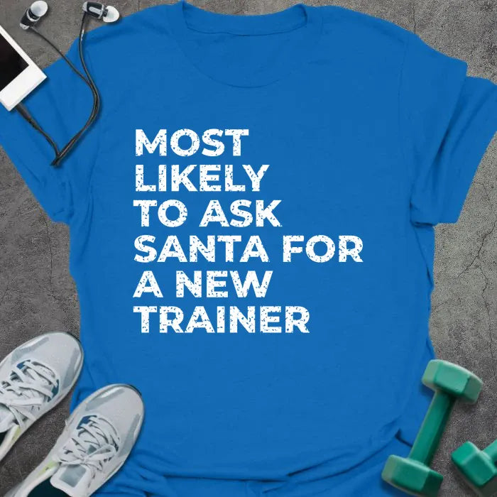 Royal blue t-shirt printed with "MOST LIKELY TO ASK SANTA FOR A NEW TRAINER" in white