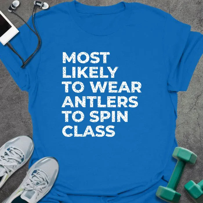 Royal blue t-shirt printed with "MOST LIKELY TO WEAR ANTLERS TO SPIN CLASS" in white