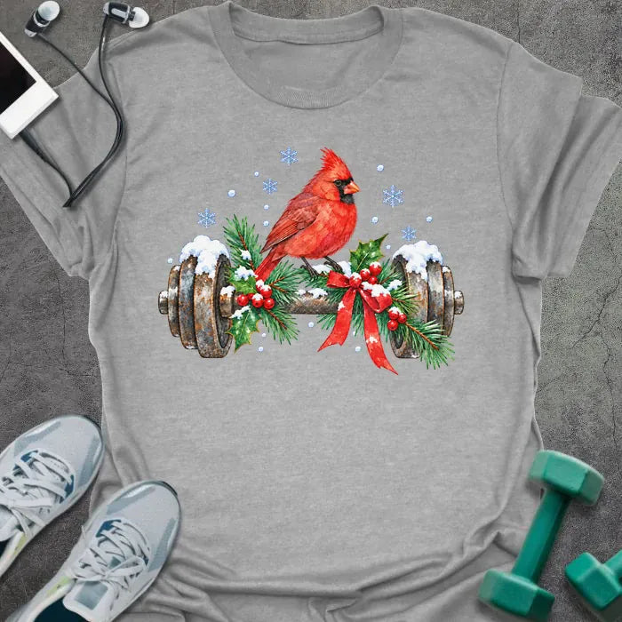Sport grey t-shirt printed with a watercolor red cardinal perched on a snowy dumbbell trimmed with holly, pine branches and a red bow, with blue snowflakes