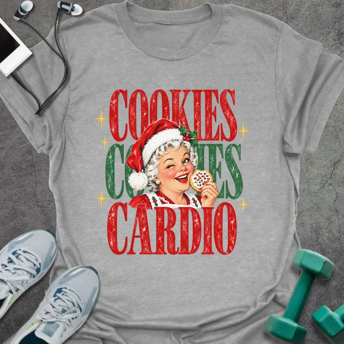 Sport grey t-shirt printed with "COOKIES COOKIES CARDIO" in red and green, with a vintage Mrs. Claus in a Santa hat winking and holding a frosted cookie