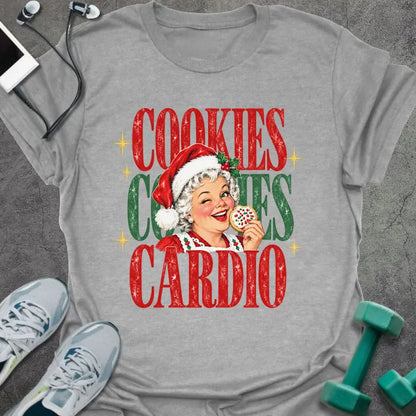 Sport grey t-shirt printed with "COOKIES COOKIES CARDIO" in red and green, with a vintage Mrs. Claus in a Santa hat winking and holding a frosted cookie