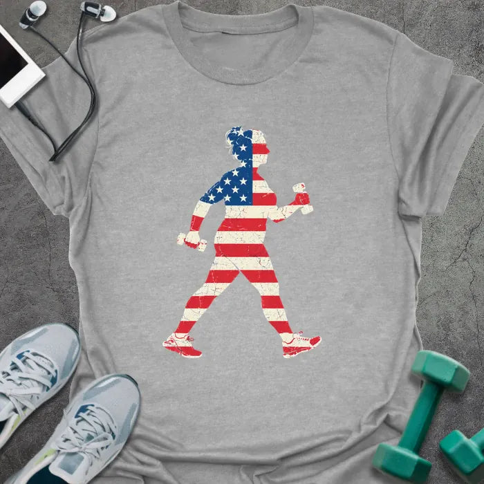 Sport grey t-shirt printed with a woman power walking with hand weights, filled with a distressed American flag