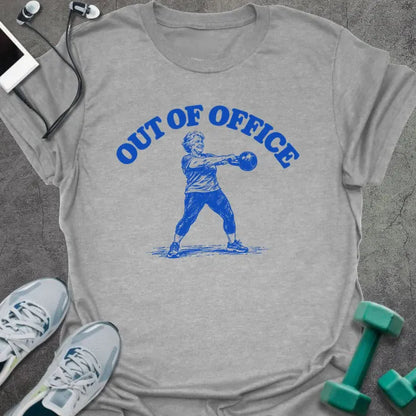 Sport grey t-shirt printed with "OUT OF OFFICE" in blue, with a sketch of an older woman swinging a kettlebell
