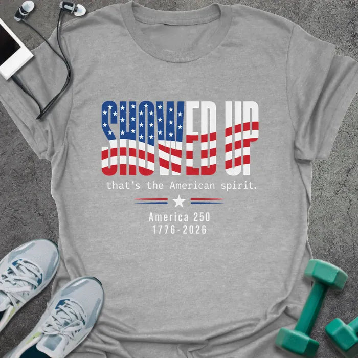 Sport grey t-shirt printed with "FIND UP that's the American spirit. America 250 1776-2026" in white and red, with an American flag graphic