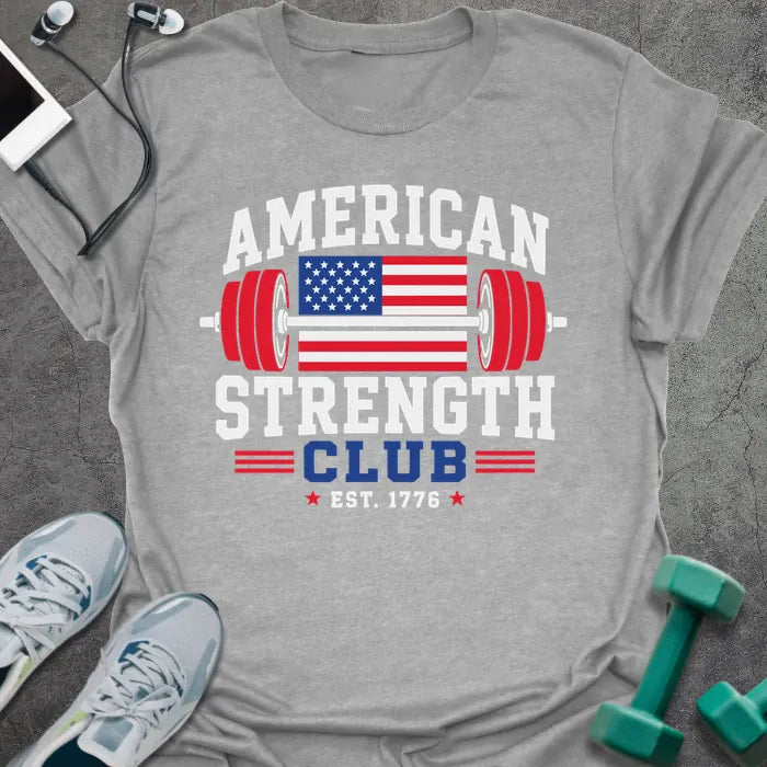 Sport grey t-shirt printed with "American Strength Club Est. 1776" in white, red, and blue, with a stars-and-stripes barbell and eagle