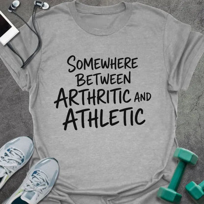 Sport grey t-shirt printed with "SOMEWHERE BETWEEN ARTHRITIC AND ATHLETIC" in black