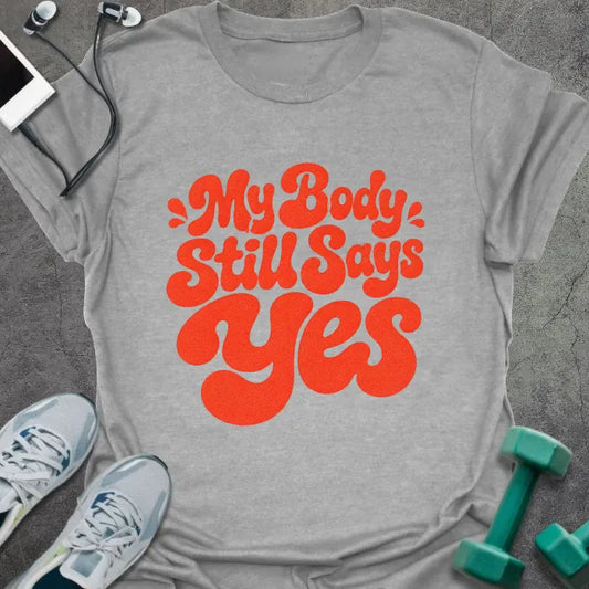 Sport Grey t-shirt printed with "My Body Still Says Yes" in red decorative script lettering