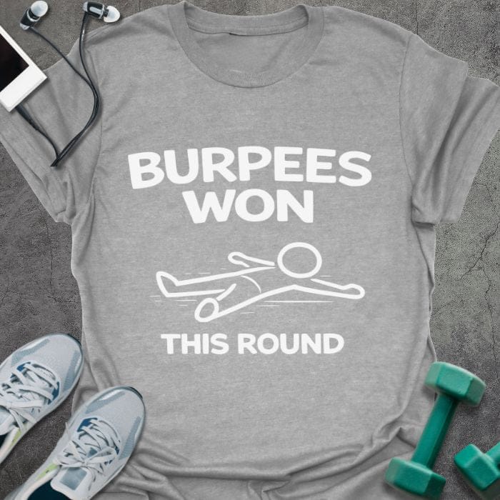 Sport grey t-shirt printed with "Burpees Won This Round" in white, with an illustration of a stick figure on the ground