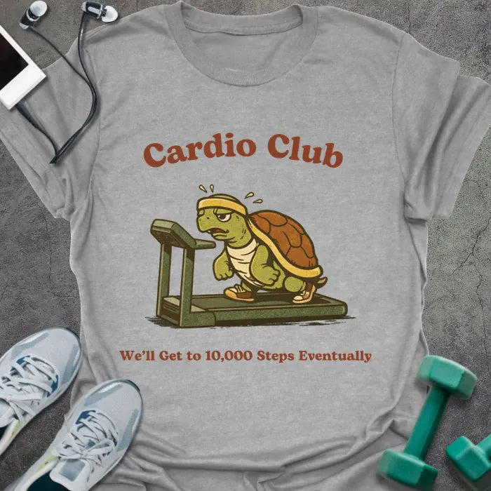 Sport grey t-shirt printed with "Cardio Club We'll Get to 10,000 Steps Eventually" in brown and red, with turtle on treadmill graphic