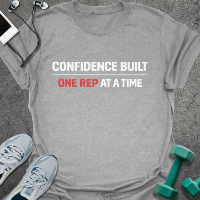 Sport grey t-shirt printed with "Confidence Built One Rep at a Time" in white and red