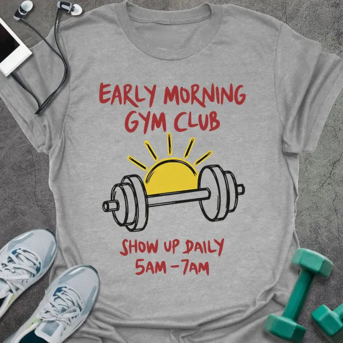 Sport grey t-shirt printed with "Early Morning Gym Club Show Up Daily 5AM-7AM" in red, yellow, and black, with a yellow sun and black dumbbell illustration