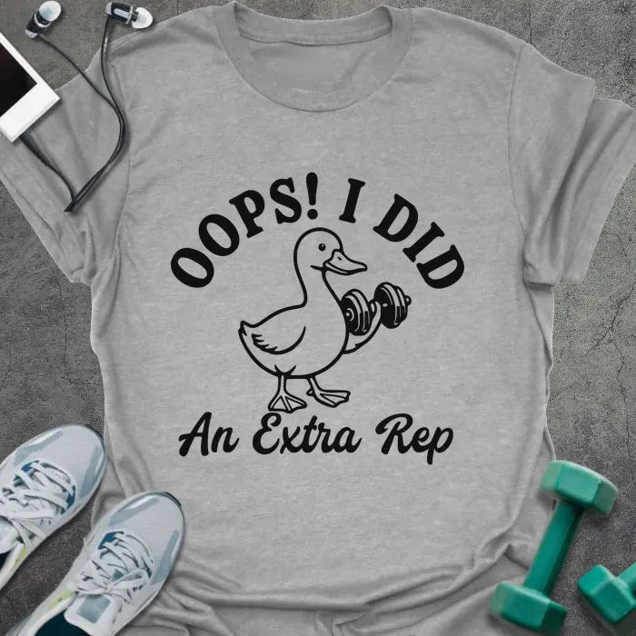 Sport grey t-shirt printed with "OOPS! I DID An Extra Rep" in black, with a duck holding a dumbbell