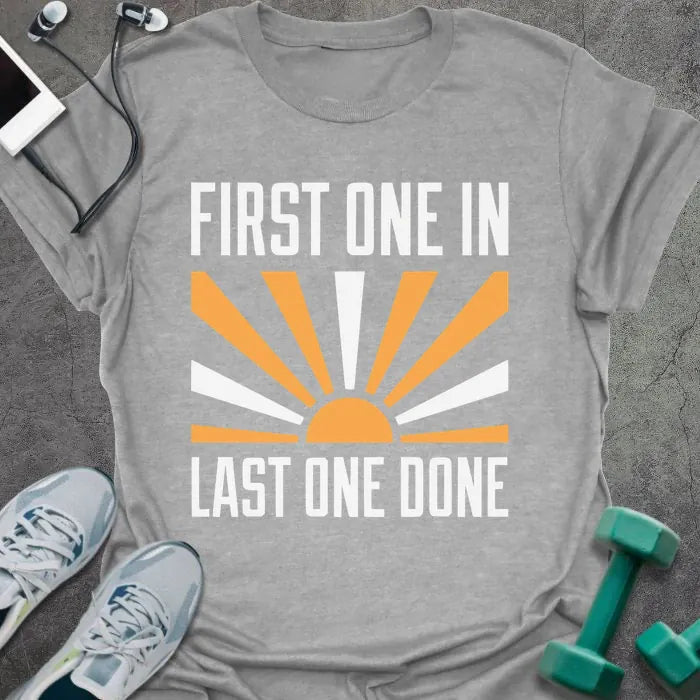 Sport grey t-shirt printed with "First One in Last One Done" in orange and white, with sun graphic