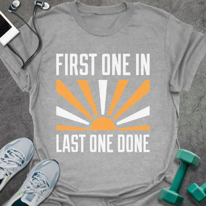 Sport grey t-shirt printed with "First One in Last One Done" in orange and white, with sun graphic