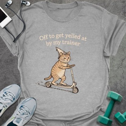 Sport grey t-shirt printed with "Off to get yelled at by my trainer" in tan, white, with a cat on a scooter