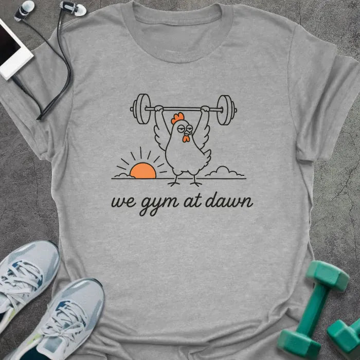 Sport grey t-shirt printed with "we gym at dawn" in orange, with a bird lifting weights at sunrise