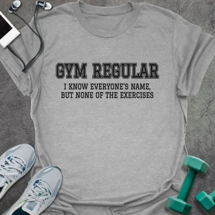 Sport grey t-shirt printed with "GYM REGULAR, I KNOW EVERYONE'S NAME, BUT NONE OF THE EXERCISES" in charcoal