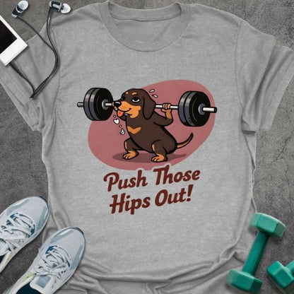 Sport grey t-shirt printed with "Push Those Hips Out!" in tan, brown, with a dachshund lifting a barbell