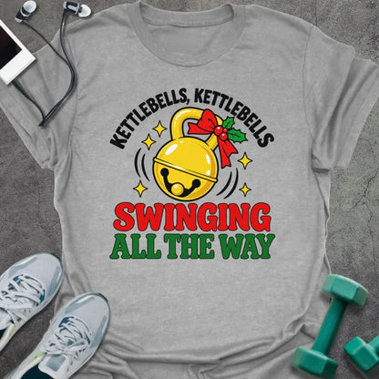 Sport grey t-shirt printed with "KETTLEBELLS, KETTLEBELLS, SWINGING ALL THE WAY" in black, red and green, with a gold jingle bell kettlebell and holly