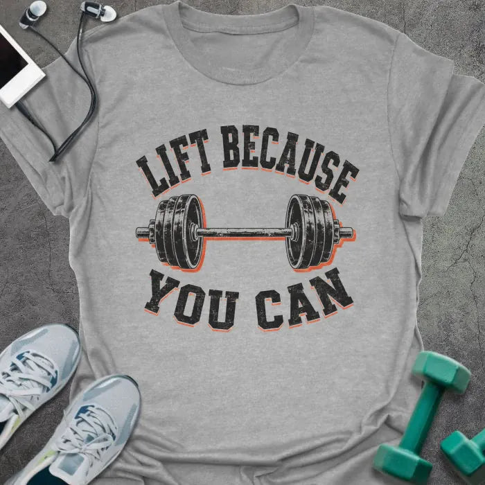 Sport Grey t-shirt printed with "LIFT BECAUSE YOU CAN" in black and red text with a barbell graphic