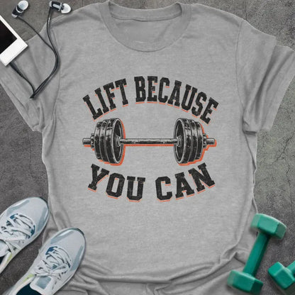 Sport Grey t-shirt printed with "LIFT BECAUSE YOU CAN" in black and red text with a barbell graphic