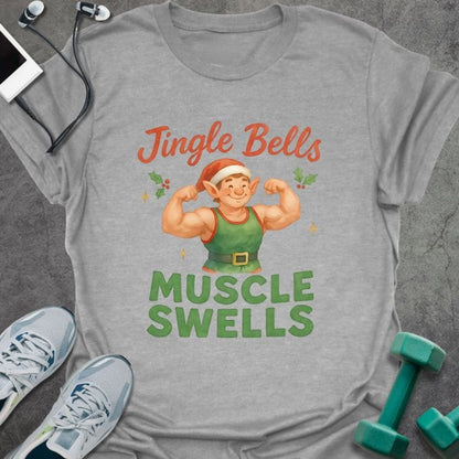 Sport grey t-shirt printed with "Jingle Bells MUSCLE SWELLS" in red and green, with an illustration of a leprechaun flexing