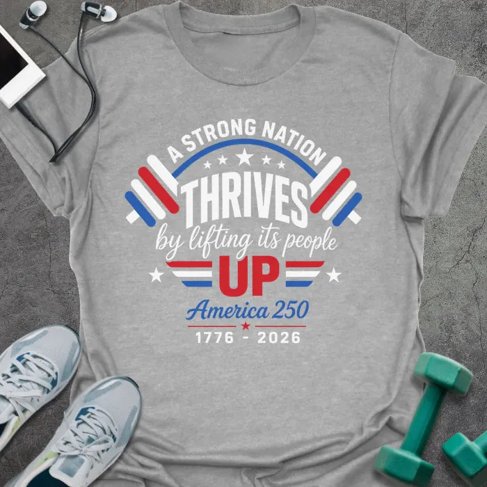 Sport grey t-shirt printed with "A STRONG NATION THRIVES by lifting its people UP" in red and white, with barbells and stars in American flag style