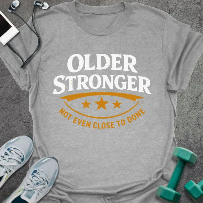 Sport grey t-shirt printed with "Older Stronger Not Even Close to Done" in white and orange, with a scoreboard showing three stars