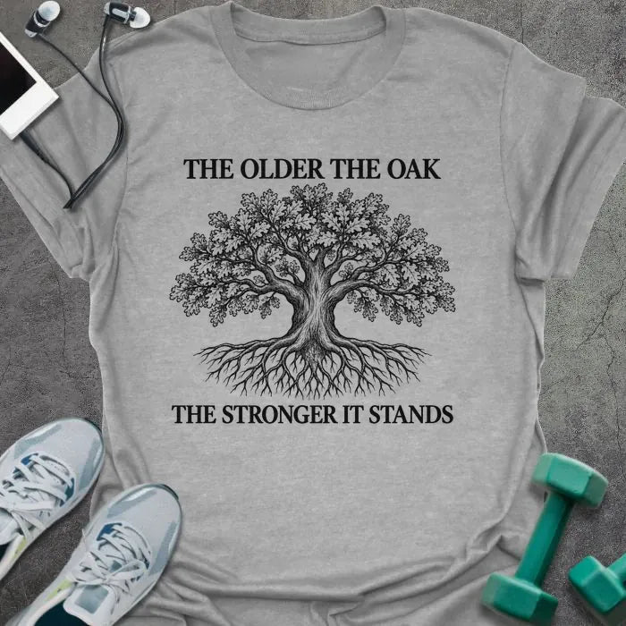 Sport grey t-shirt printed with "THE OLDER THE OAK, THE STRONGER IT STANDS" in black, with a drawing of an oak tree and its roots