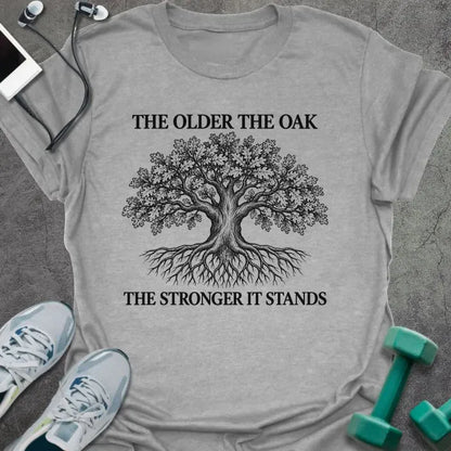 Sport grey t-shirt printed with "THE OLDER THE OAK, THE STRONGER IT STANDS" in black, with a drawing of an oak tree and its roots
