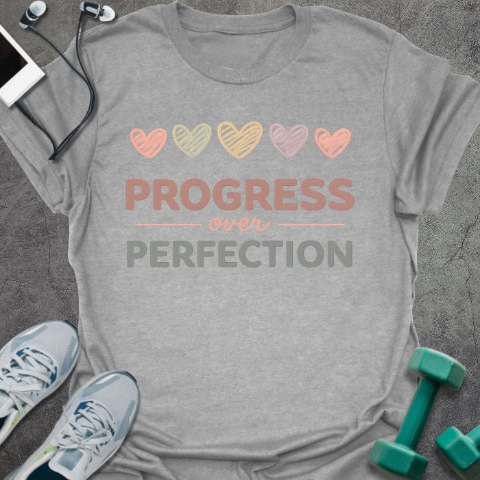 Sport grey t-shirt printed with "PROGRESS over PERFECTION" in multi-color, with five hearts in pastel colors
