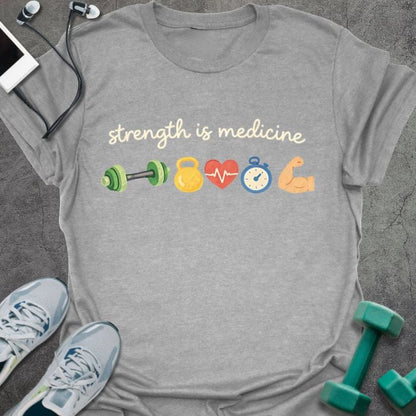 Sport grey t-shirt printed with "strength is medicine" in multicolor, with emoji icons: dumbbell, kettlebell, heart, timer, muscle