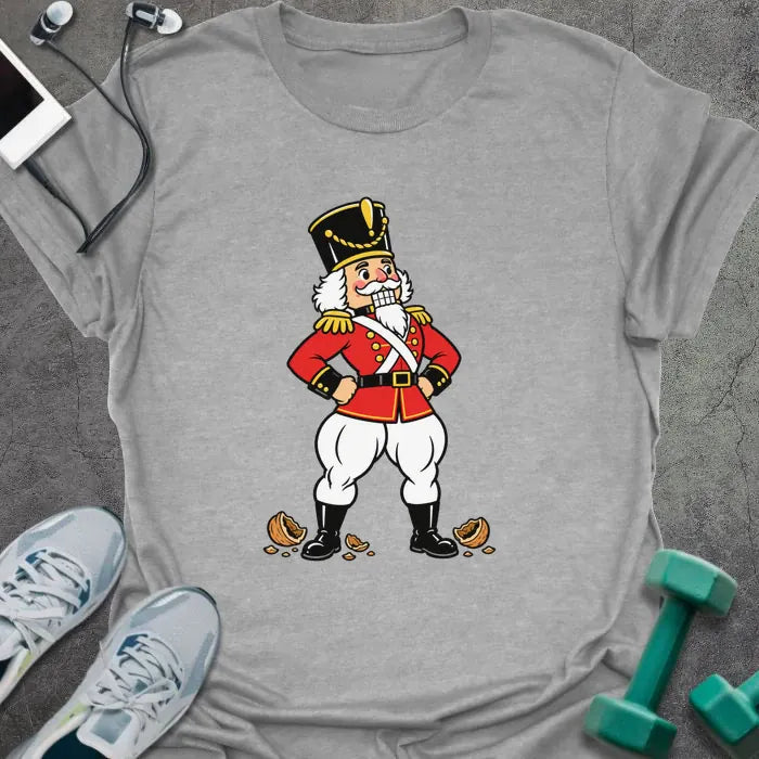 Sport grey t-shirt printed with a vintage nutcracker soldier with strong legs, hands on hips, standing over cracked nutshells