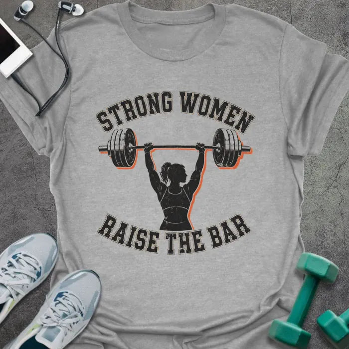 Sport Grey t-shirt printed with "STRONG WOMEN RAISE THE BAR" in black lettering, with a silhouette of a woman weightlifter raising a barbell overhead