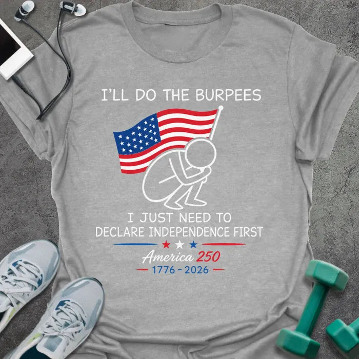 Sport grey t-shirt printed with "I'll Do the Burpees I Just Need to Declare Independence First" in red and white, with a figure doing burpees and American flag